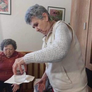 Városi Humánsegítő és Szociális Szolgálat | Galéria Pohártrükköt bemutató idős hölgy.